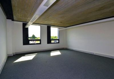 Small empty office space with two windows.