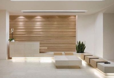 Sleek minimalist reception area with a wooden slat feature wall and integrated lighting.