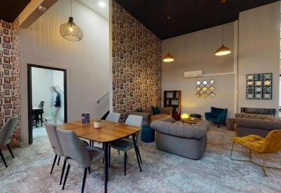 Vibrant breakout area with diverse seating options and patterned feature walls.