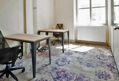 Private office suite with two minimal desks and ergonomic chairs.