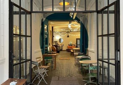 Entrance to the 16 Rue Alsace Lorraine building seen through a glass and black metal framed partition.
