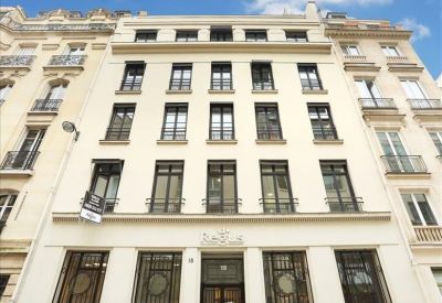 Reception area with white desk and modern lighting.