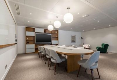 Large conference room featuring a long oval table and spherical pendant lighting.