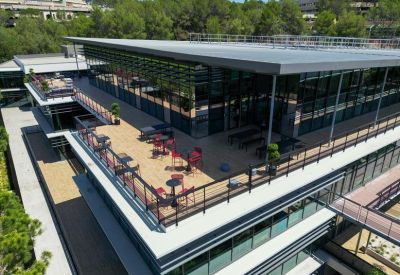 Spacious rooftop terrace with lounge seating and glass railings.