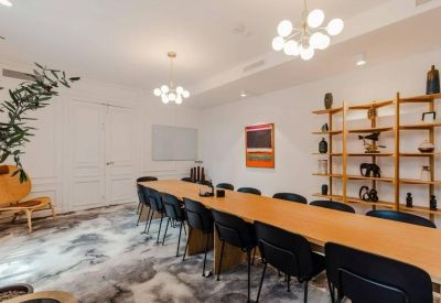 Professional meeting room with a long table and modern shelving.