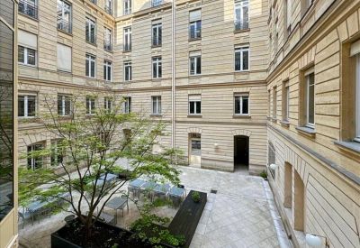 Bright meeting room with light green walls and blue velvet chairs.
