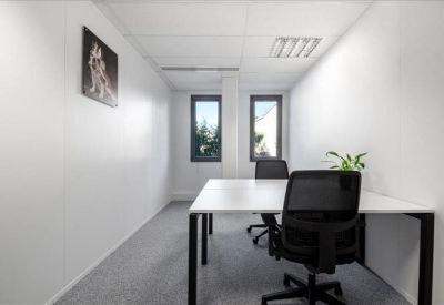 Private two-person office suite with white desks and black ergonomic chairs.