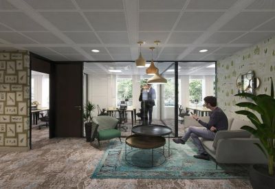 Modern lounge area with round coffee tables and turquoise area rug.