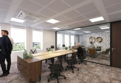 Professional workstation area with long wooden desks and ergonomic black chairs.