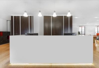 Modern reception desk area with minimalist white counter and designer pendant lights.
