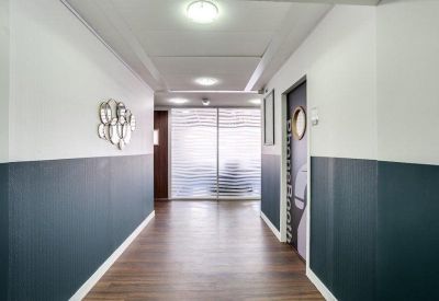 Modern hallway with two-tone grey and white walls and circular wall decor.