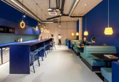 Blue-themed kitchen and cafe area with booth seating and long breakfast bar.