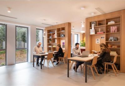 Cozy workspace featuring wooden shelving units and small tables for focused work.