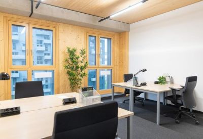 Bright office suite with wood panelled walls and large windows.