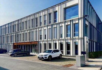 Bright private office with two desks and large windows.