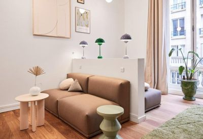 Bright break-out area with a low-profile modular sofa and decorative table lamps.