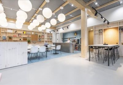 Spacious communal area with round pendant lights and varied seating options.