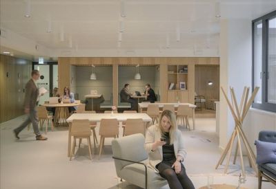 Open-plan communal area with various seating options including booths and cafe-style tables.