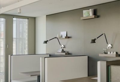 Communal breakout area with comfortable booth seating and modern task lighting.