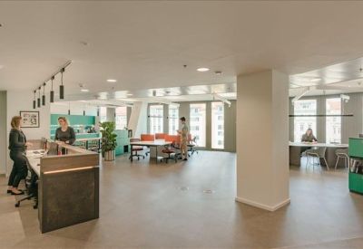Modern reception area with a dark wood desk and integrated greenery.
