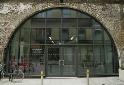 Exterior view of the arched glass entrance at 1 & 2 Spare Street set within a brick facade.