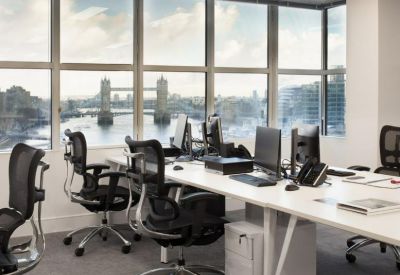 Spacious lounge area with dark wingback chairs and spherical pendant lights.