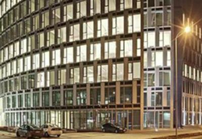 Exterior night view of a well-lit office building.