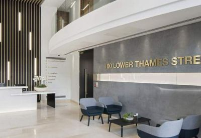 Modern reception lobby with wood-slat feature wall and grey stone branded backdrop.