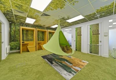 Nature-themed room with a hanging pod chair and forest wallpaper on the walls and ceiling.