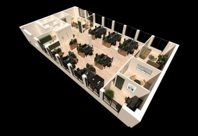 Open-plan office space with multiple workstations and natural lighting.