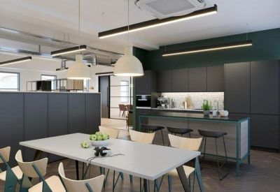 Spacious communal kitchen and dining area with a large island and grey cabinetry.