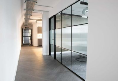 Bright hallway with glass partitioning and herringbone flooring.