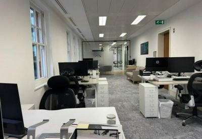Spacious open-plan workspace at 115, Park Street, London featuring rows of desks and large windows.