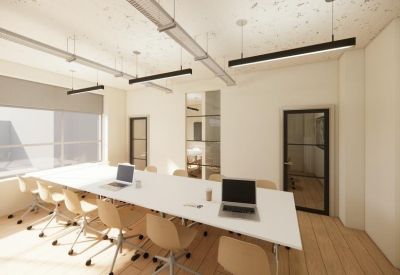 Spacious meeting room with a large white conference table, tan chairs, and sleek pendant lighting.