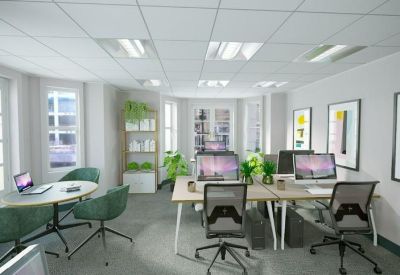 Bright open-plan coworking space with workstations and indoor plants.