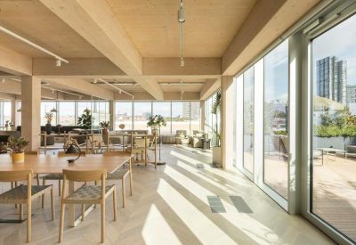 Spacious sunlit lounge with light wood beams and terrace access.