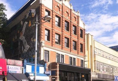 Exterior view of the brick facade and storefront at 133a Rye Lane, Peckham.