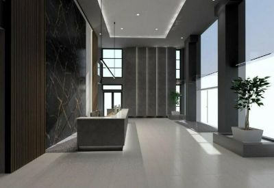 Spacious modern lobby with a dark marble feature wall and sleek reception desk.