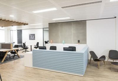 Reception area featuring a light blue slatted desk and modern lounge seating.