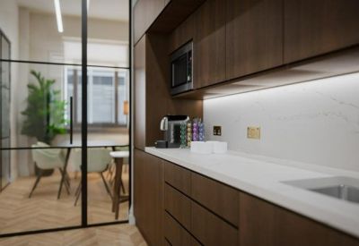 Sleek office kitchenette with dark wood cabinetry, white marble backsplash, and a view into a glass-walled boardroom.