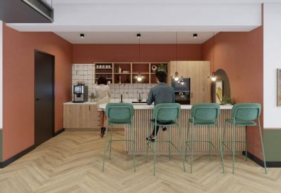 Bright kitchen breakout space featuring a wooden island and modern teal bar stools.
