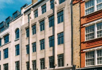 Exterior view of the stone facade building at 140 Wardour St, London.