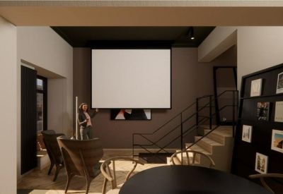 Versatile meeting area with a large projection screen and tiered seating stairs.
