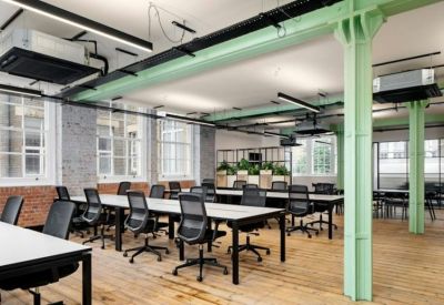 Spacious open-plan workspace at 15 Ironmonger Row with industrial green beams and rows of desks.