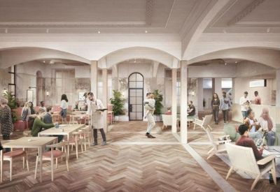 Bright communal lounge and cafe area with arched ceilings and herringbone wood floors.