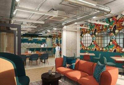 Vibrant communal lounge with an orange sofa and a colorful bird-patterned feature wall.