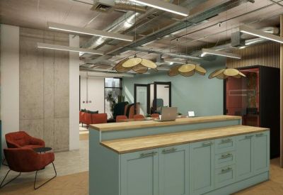 Modern office breakout area featuring a sage green storage island and plush red armchairs.