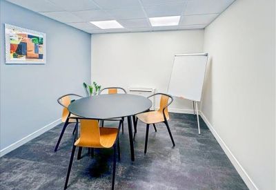 Contemporary office kitchen with teal cabinetry and a white countertop.