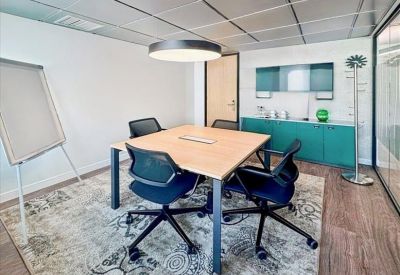 Bright reception area with a long counter and a comfortable waiting lounge in the background.