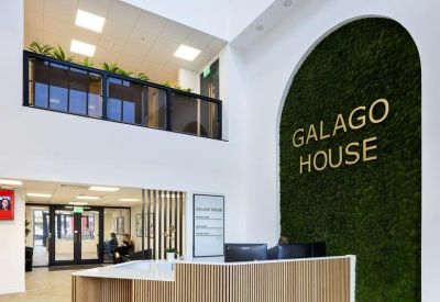 Reception desk at Galago House, 163 Bright Road, featuring a large moss feature wall and wooden slats.